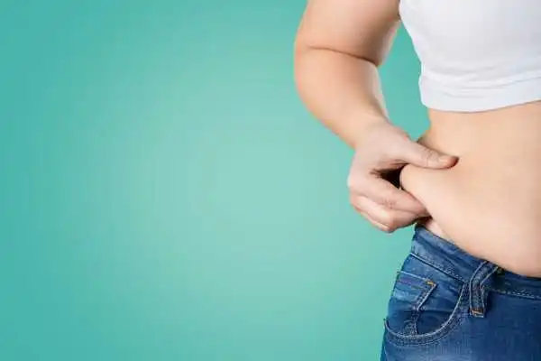 Image of woman pinching her love handles to show weight gain Allesley Green